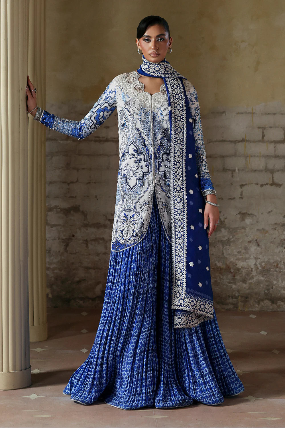 Model wearing Evadia by Soraya in ivory and royal blue printed outfit – Pakistani luxury pret available online in UK for festive wear.
