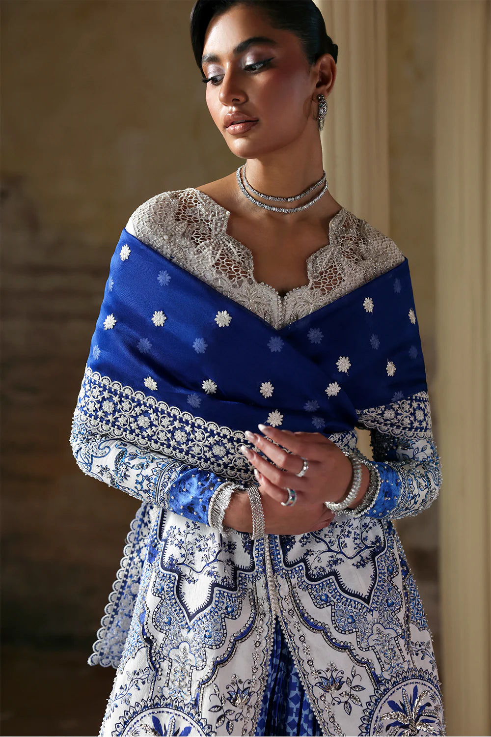 Model wearing Evadia by Soraya in ivory and royal blue printed outfit – Pakistani luxury pret available online in UK for festive wear.