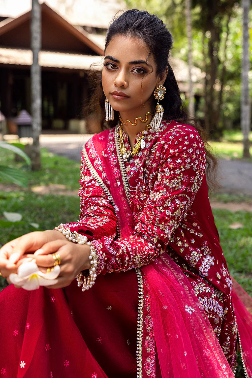 Model wearing Saira Rizwan GOLNAR-SRF25-01 in deep red with gold embellishments – Pakistani luxury pret, shop online in UK.