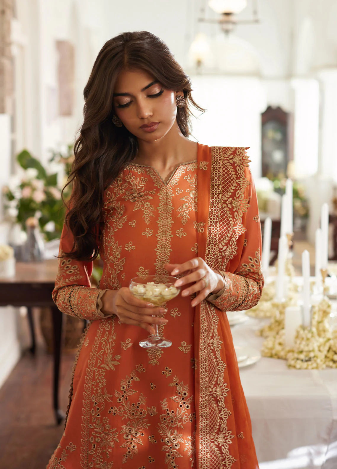 Model wearing rust orange Solara from Gulaal Lumiere Chikankaari Lawn, Pakistani luxury pret and Pakistani clothes online in UK.