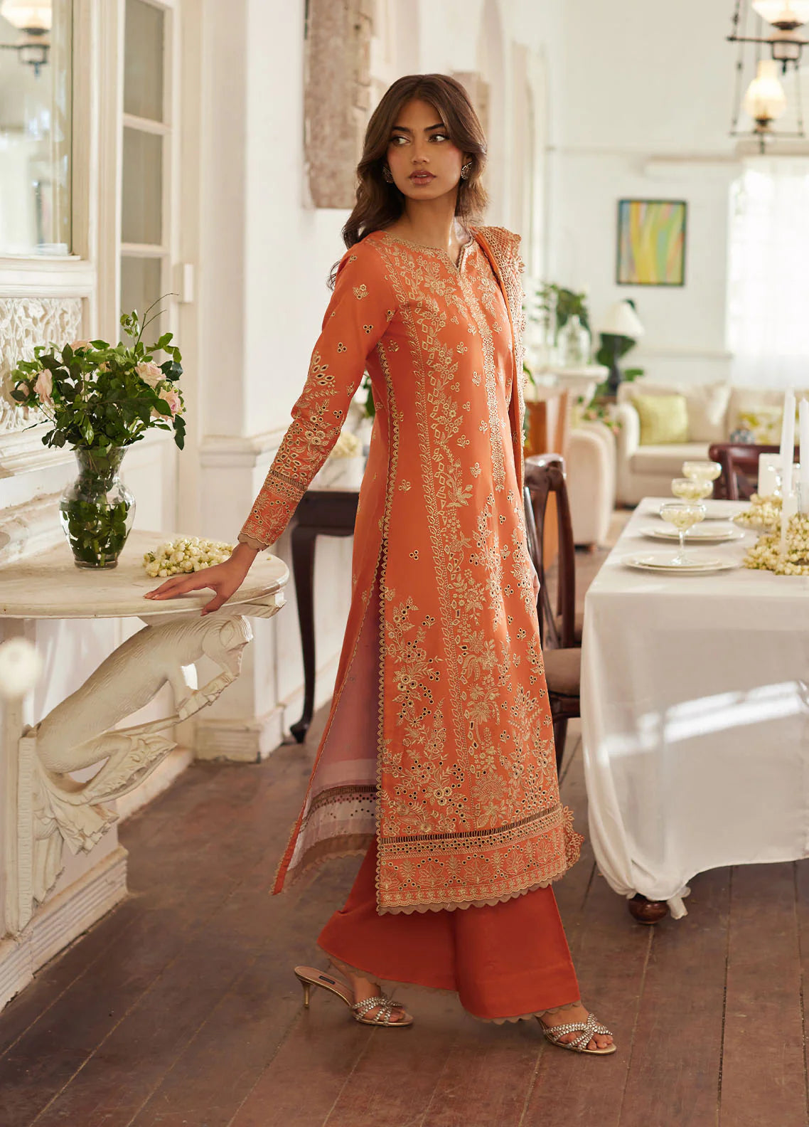 Model wearing rust orange Solara from Gulaal Lumiere Chikankaari Lawn, Pakistani luxury pret and Pakistani clothes online in UK.