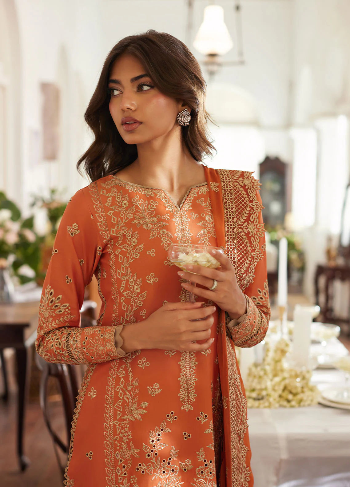Model wearing rust orange Solara from Gulaal Lumiere Chikankaari Lawn, Pakistani luxury pret and Pakistani clothes online in UK.