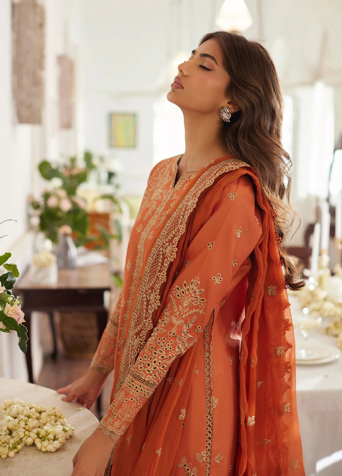Model wearing rust orange Solara from Gulaal Lumiere Chikankaari Lawn, Pakistani luxury pret and Pakistani clothes online in UK.