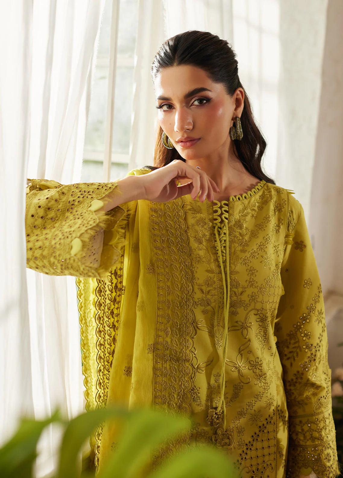 Model wearing mustard yellow Aurelia from Gulaal Lumiere Chikankaari Lawn, Pakistani luxury pret and Pakistani clothes online in UK.