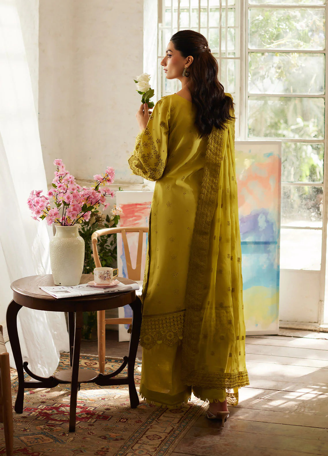 Model wearing mustard yellow Aurelia from Gulaal Lumiere Chikankaari Lawn, Pakistani luxury pret and Pakistani clothes online in UK.