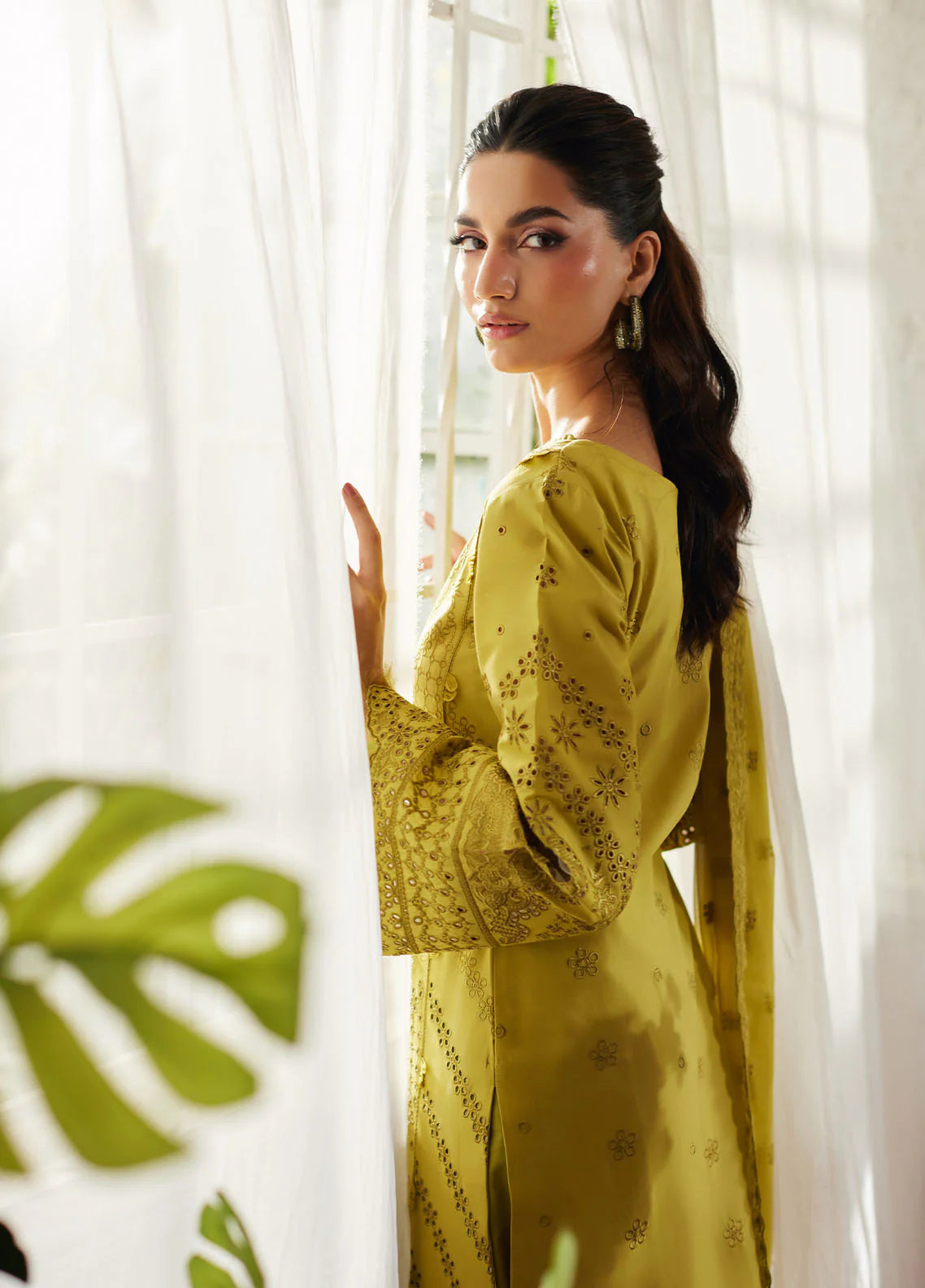 Model wearing mustard yellow Aurelia from Gulaal Lumiere Chikankaari Lawn, Pakistani luxury pret and Pakistani clothes online in UK.