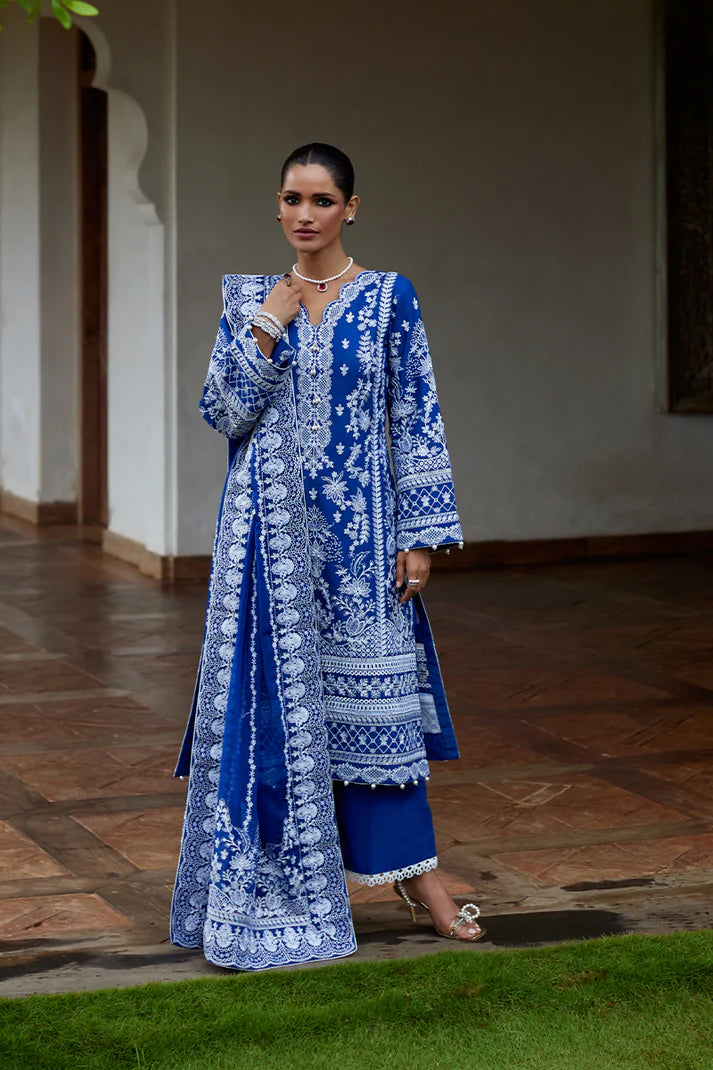 Model wearing Gulaal CYNARA royal blue luxury lawn dress with intricate white embroidery. Shop Pakistani luxury pret online in the UK.