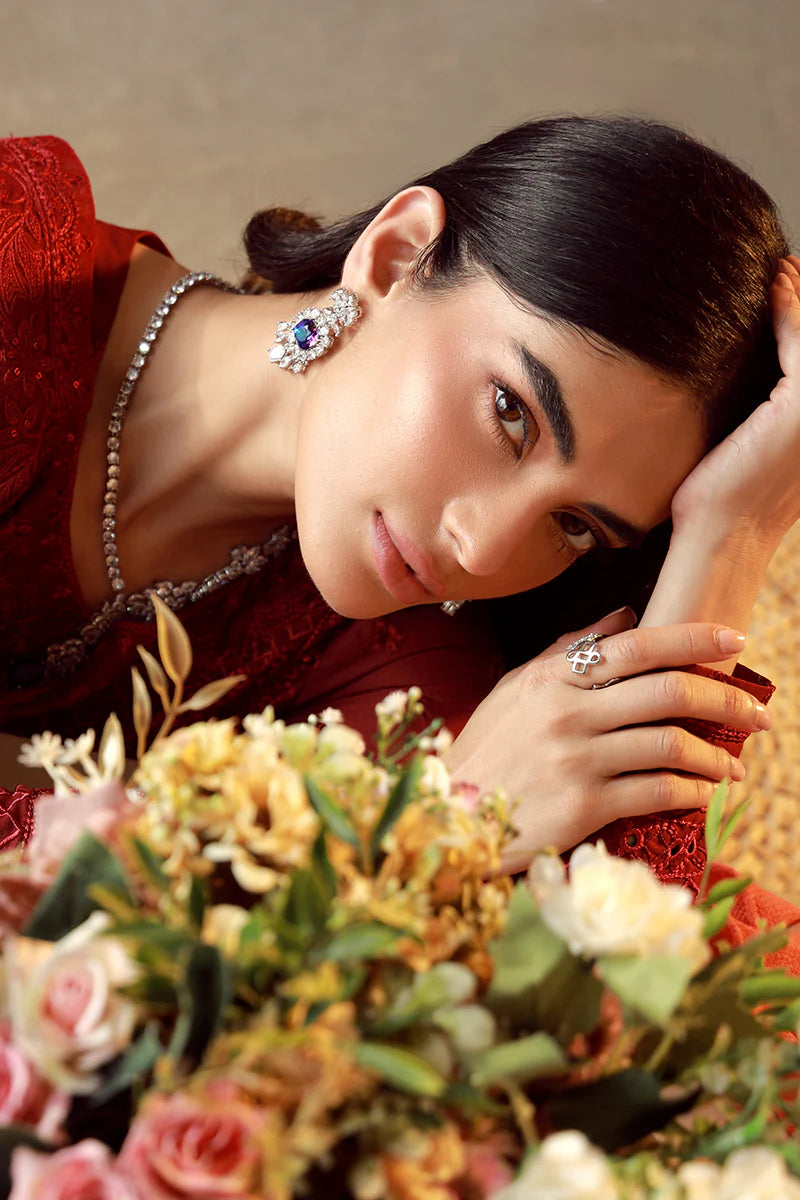 Model wearing deep red embroidered Gulaal Ella outfit, ideal for festive wear and Pakistani luxury pret available online in the UK.