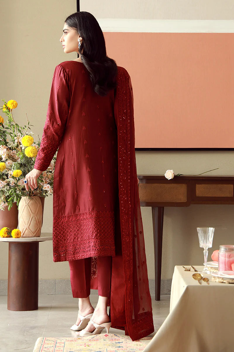 Model wearing deep red embroidered Gulaal Ella outfit, ideal for festive wear and Pakistani luxury pret available online in the UK.
