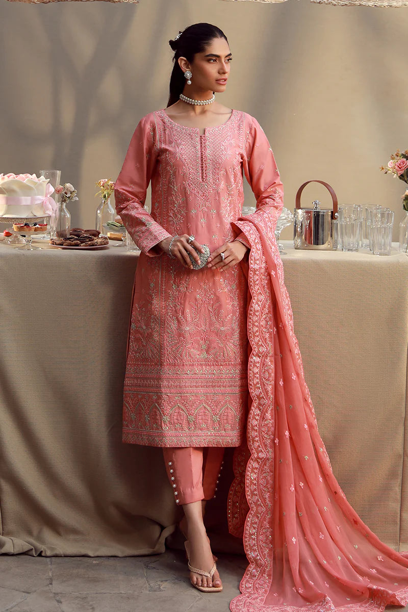 Model wearing coral pink embroidered Ira outfit from Gulaal Festive Pret, perfect for Pakistani luxury pret and Eid fashion in the UK.