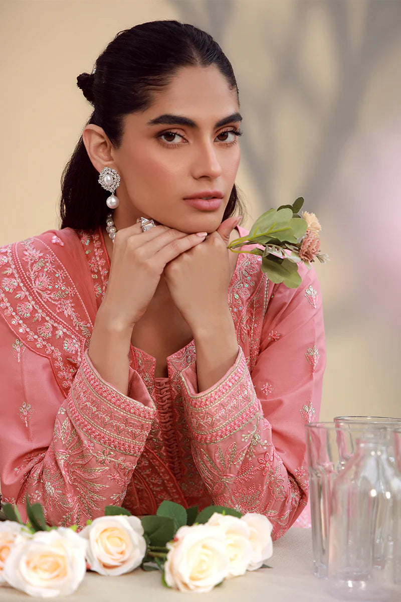 Model wearing coral pink embroidered Ira outfit from Gulaal Festive Pret, perfect for Pakistani luxury pret and Eid fashion in the UK.