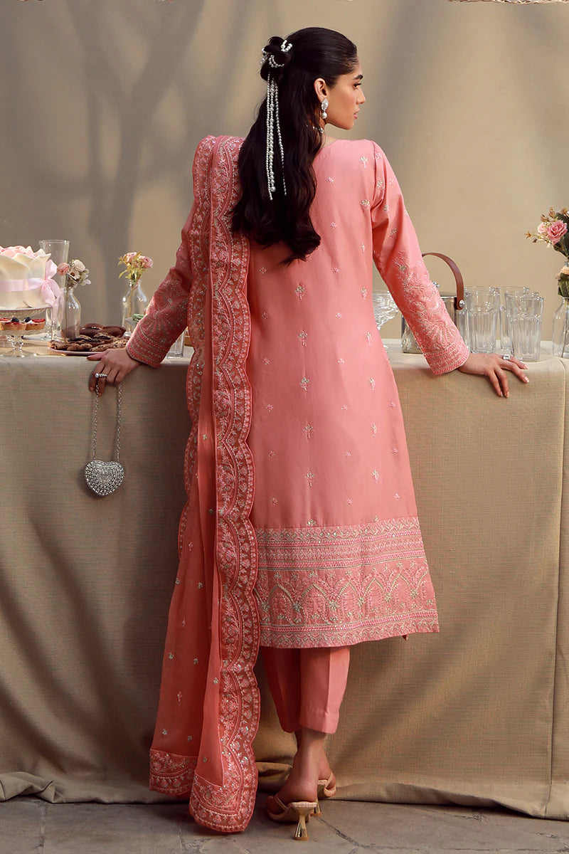Model wearing coral pink embroidered Ira outfit from Gulaal Festive Pret, perfect for Pakistani luxury pret and Eid fashion in the UK.