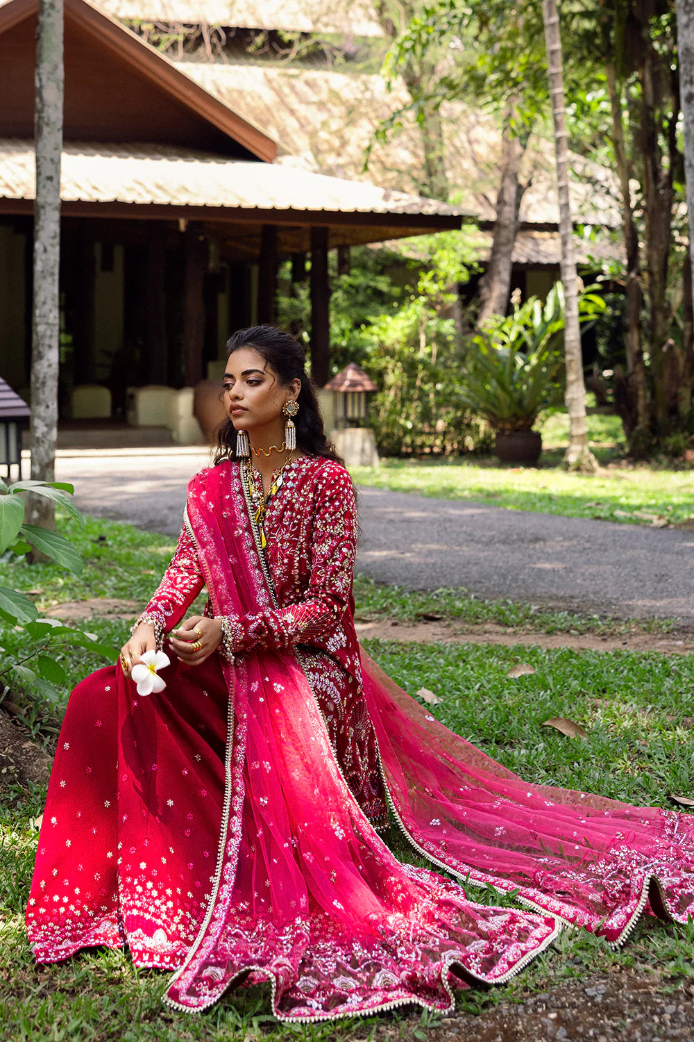 Model wearing Saira Rizwan GOLNAR-SRF25-01 in deep red with gold embellishments – Pakistani luxury pret, shop online in UK.