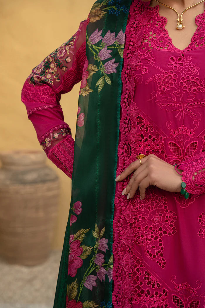 Model wearing hot pink embroidered three-piece suit with dark green printed dupatta from Saira Rizwan, Pakistani luxury pret, Pakistani clothes online in UK.