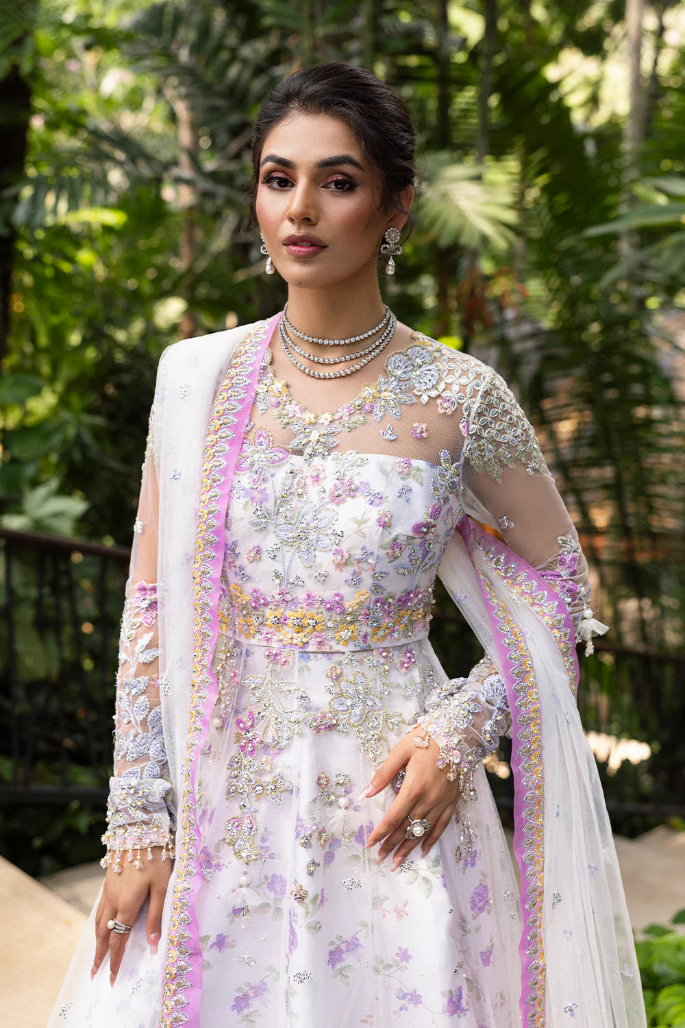 Model wearing Saira Rizwan ELINA-SRF25-05 in white and lilac floral embroidery – Pakistani luxury pret, shop online in UK.