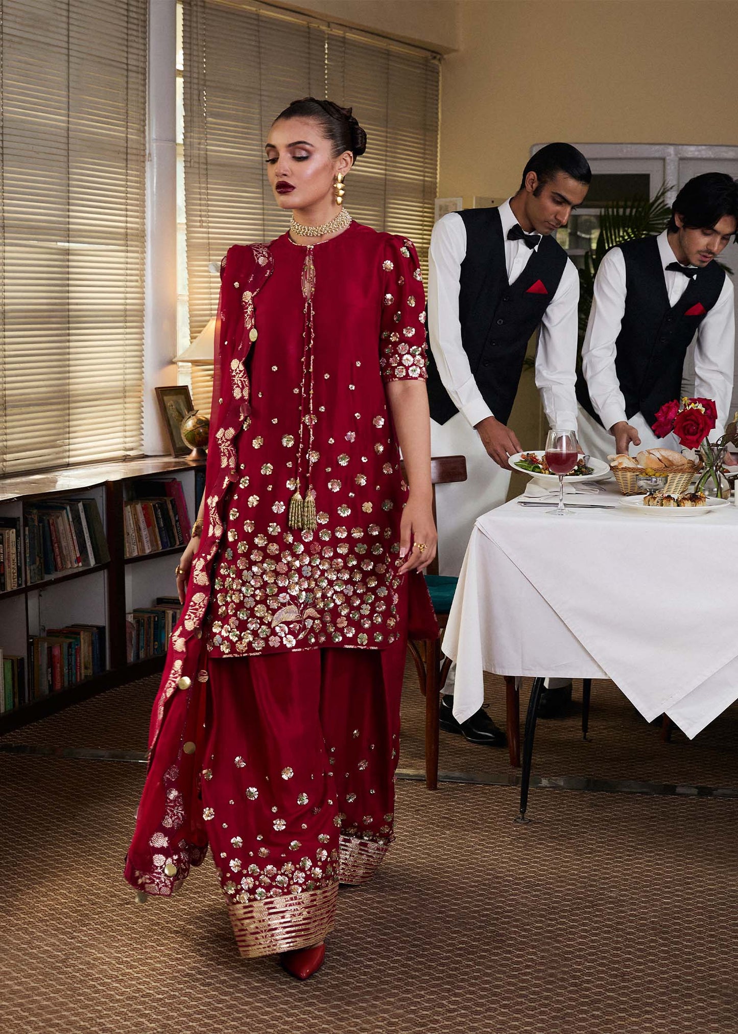 Model wearing Hussain Rehar SS Luxury Pret '25 Rasp in deep red with intricate embellishments. Shop Pakistani luxury pret online in the UK.