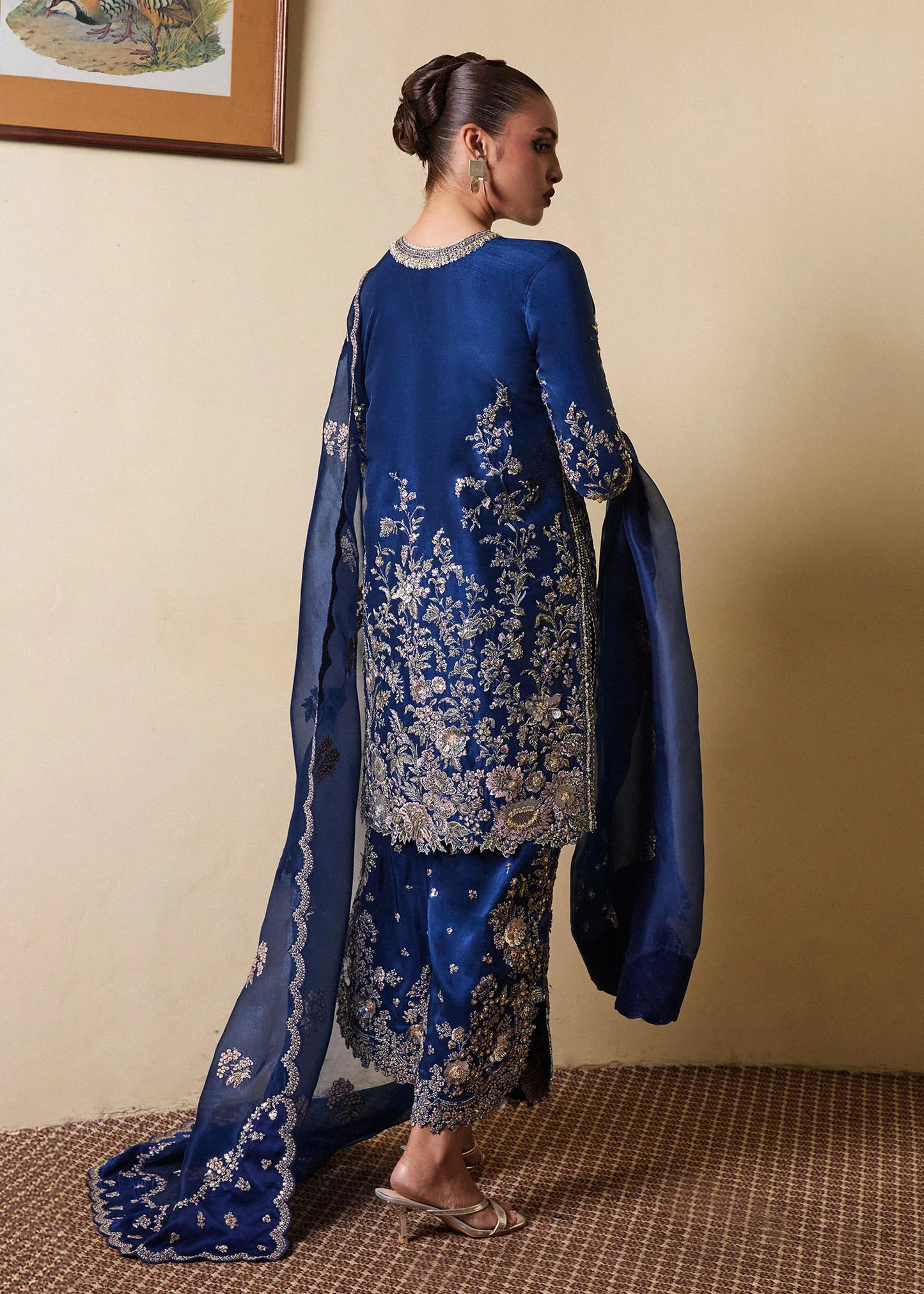 Model wearing Hussain Rehar SS Luxury Pret '25 Twil in navy blue with intricate gold embellishments. Shop Pakistani luxury pret online in the UK.