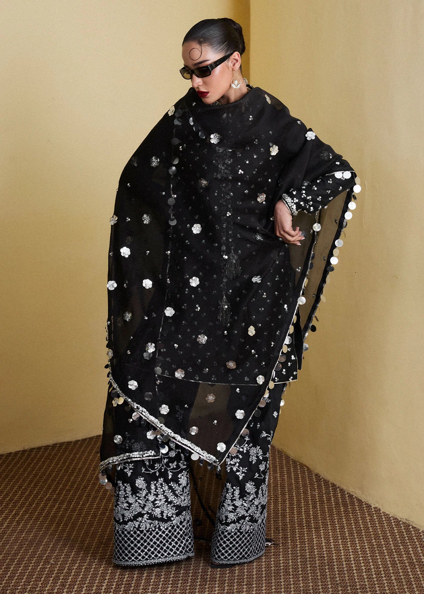 Model wearing Hussain Rehar SS Luxury Pret '25 Kiara in black with silver embellishments. Shop Pakistani luxury pret online in the UK.