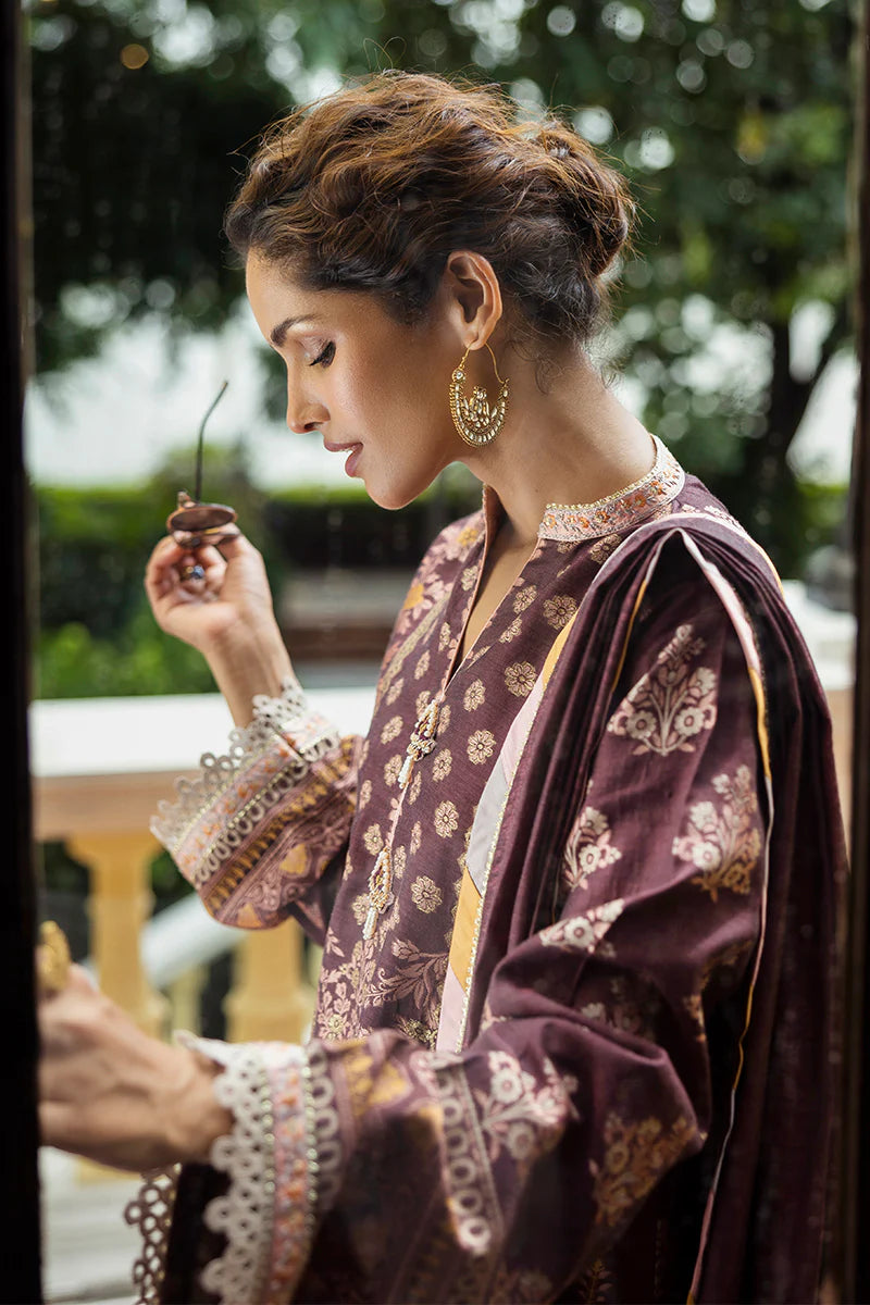 Model wearing deep plum and gold Narissa dress from Mushq Seraph Jacquard Lawn '25, Pakistani Luxury pret, Pakistani clothes online in UK.