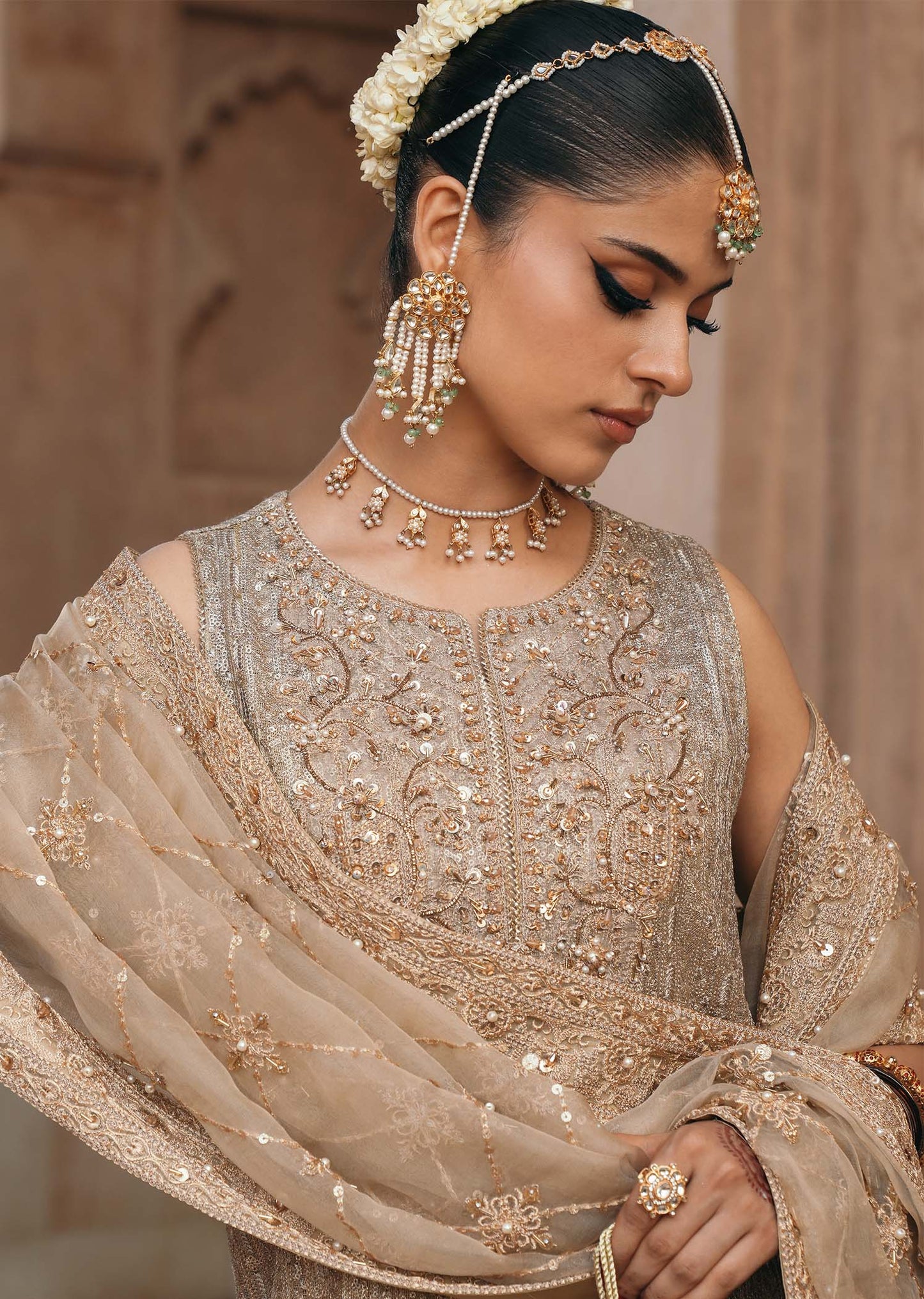 Model wearing Sitara by Kanwal Malik in champagne gold with intricate embellishments – stunning Pakistani luxury pret outfit in UK.