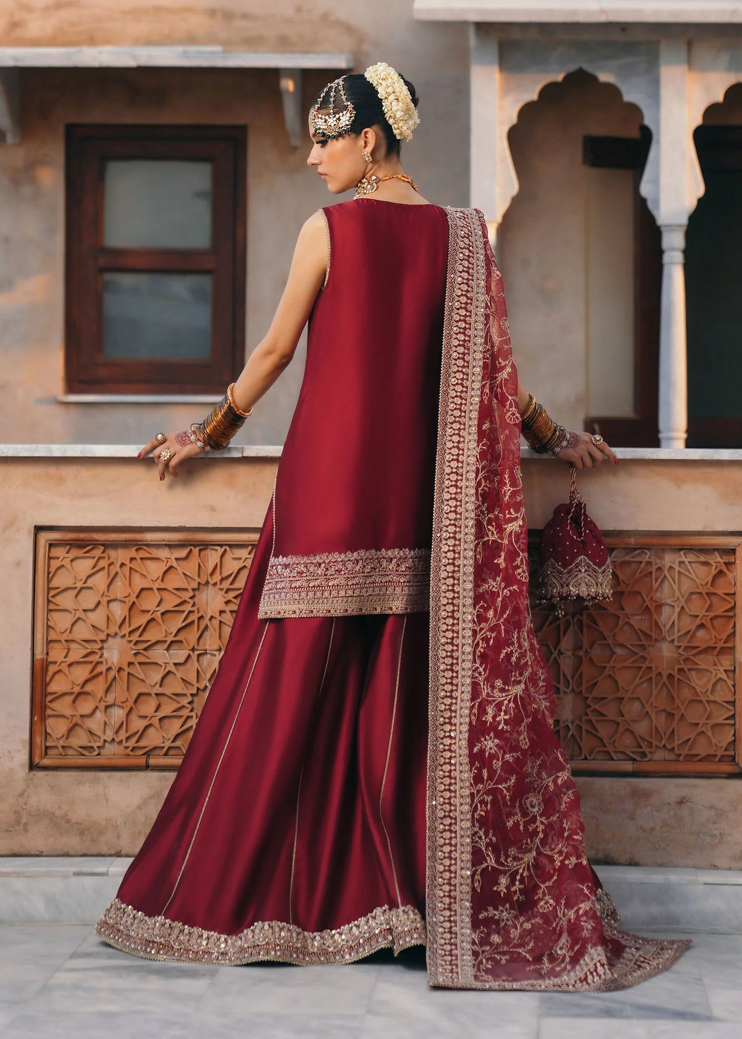 Model wearing Mehek by Kanwal Malik in deep maroon with gold embroidery and net dupatta – elegant Pakistani luxury pret outfit in UK.