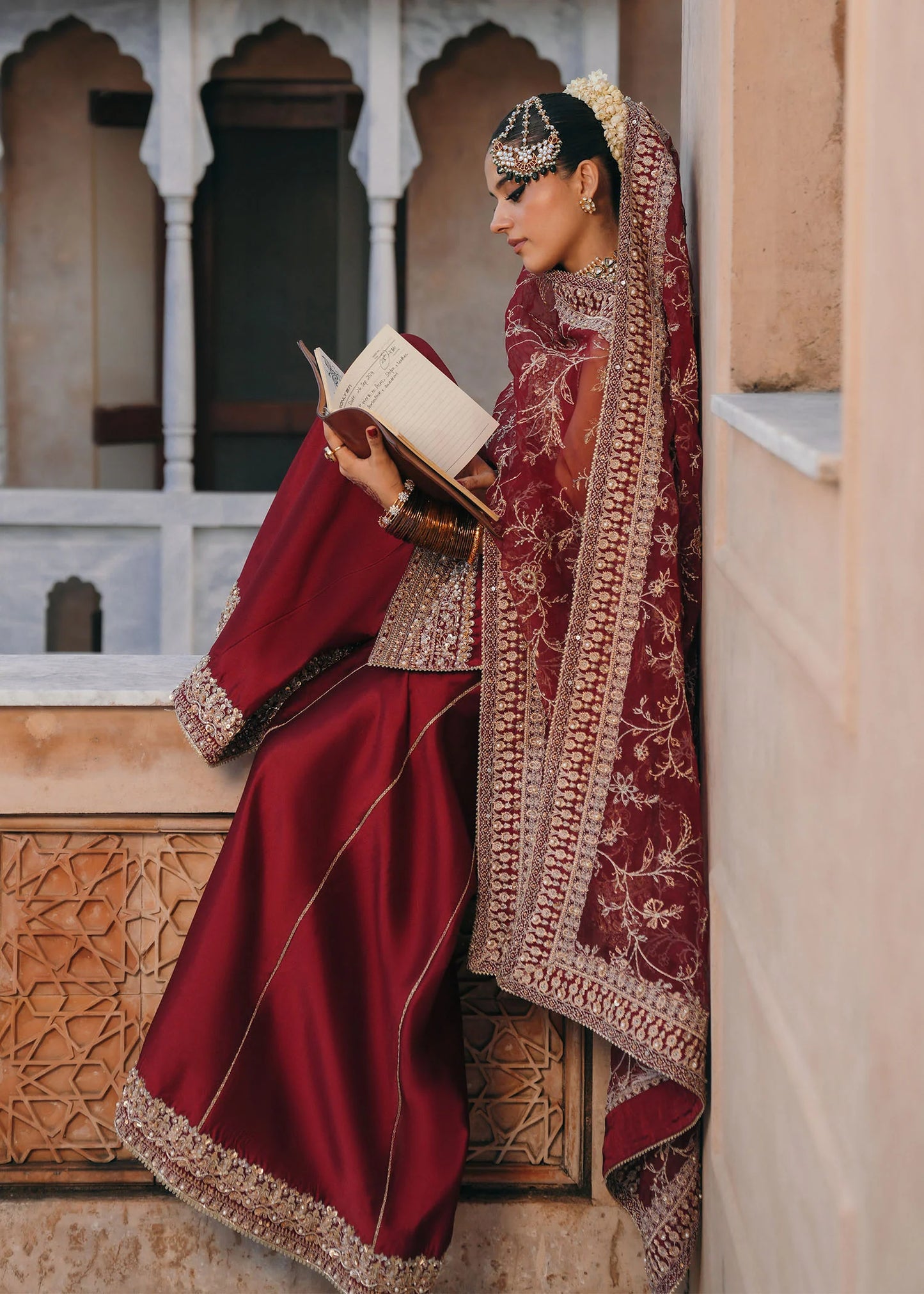 Model wearing Mehek by Kanwal Malik in deep maroon with gold embroidery and net dupatta – elegant Pakistani luxury pret outfit in UK.