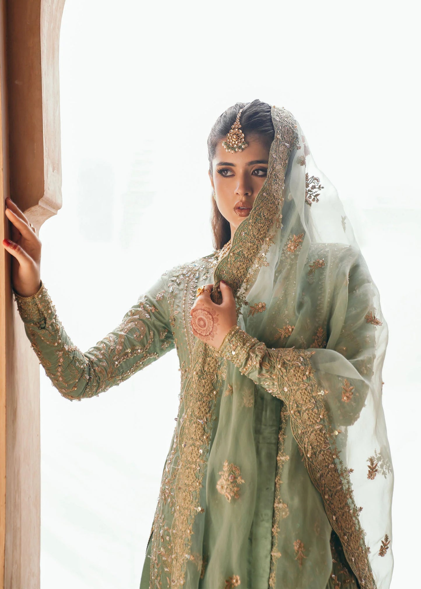 Model wearing Kaneez by Kanwal Malik in mint green with gold embroidery – luxurious Pakistani luxury pret outfit in UK.