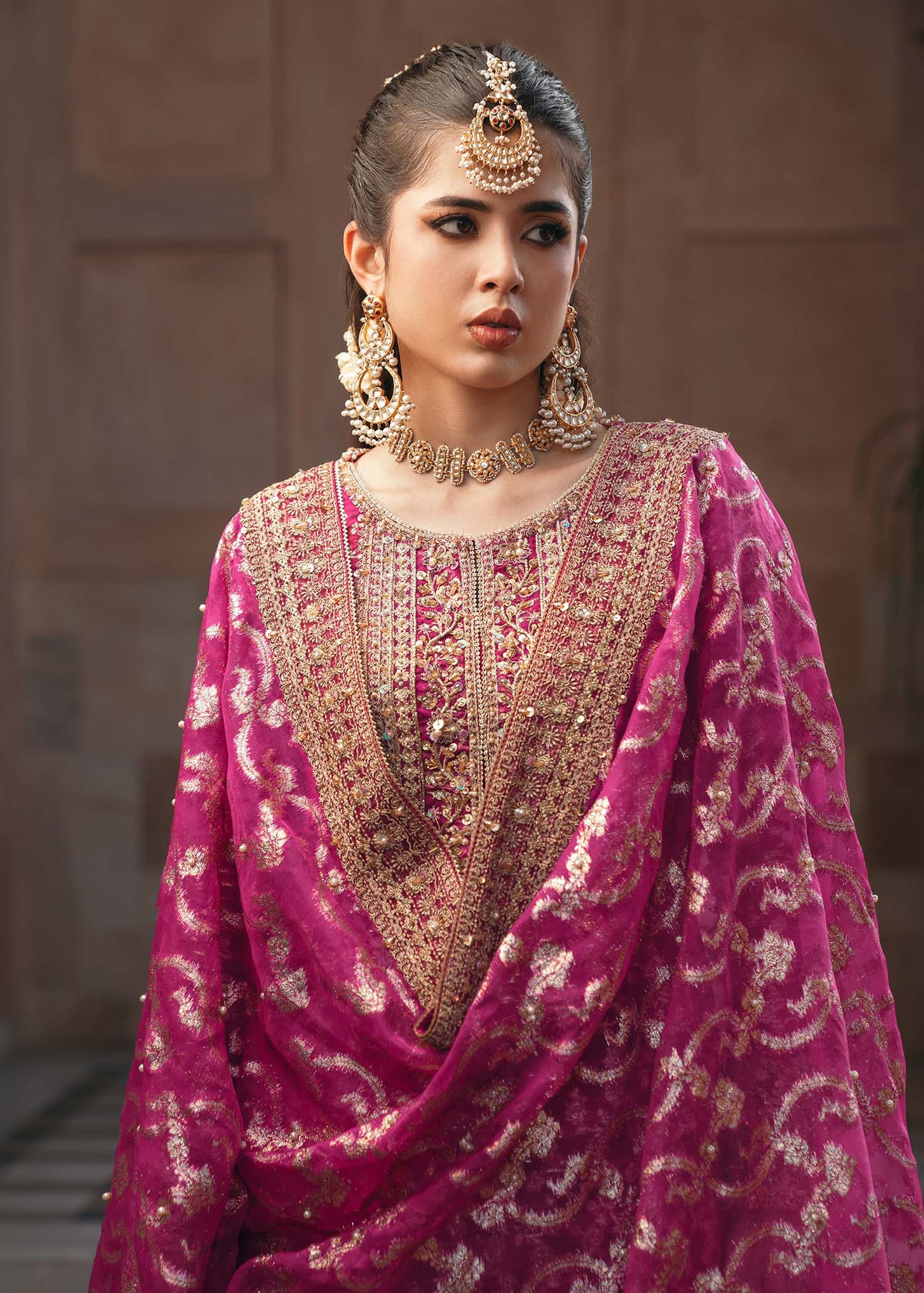 Model wearing Rano by Kanwal Malik in hot pink with intricate gold detailing – vibrant Pakistani luxury pret outfit in UK.