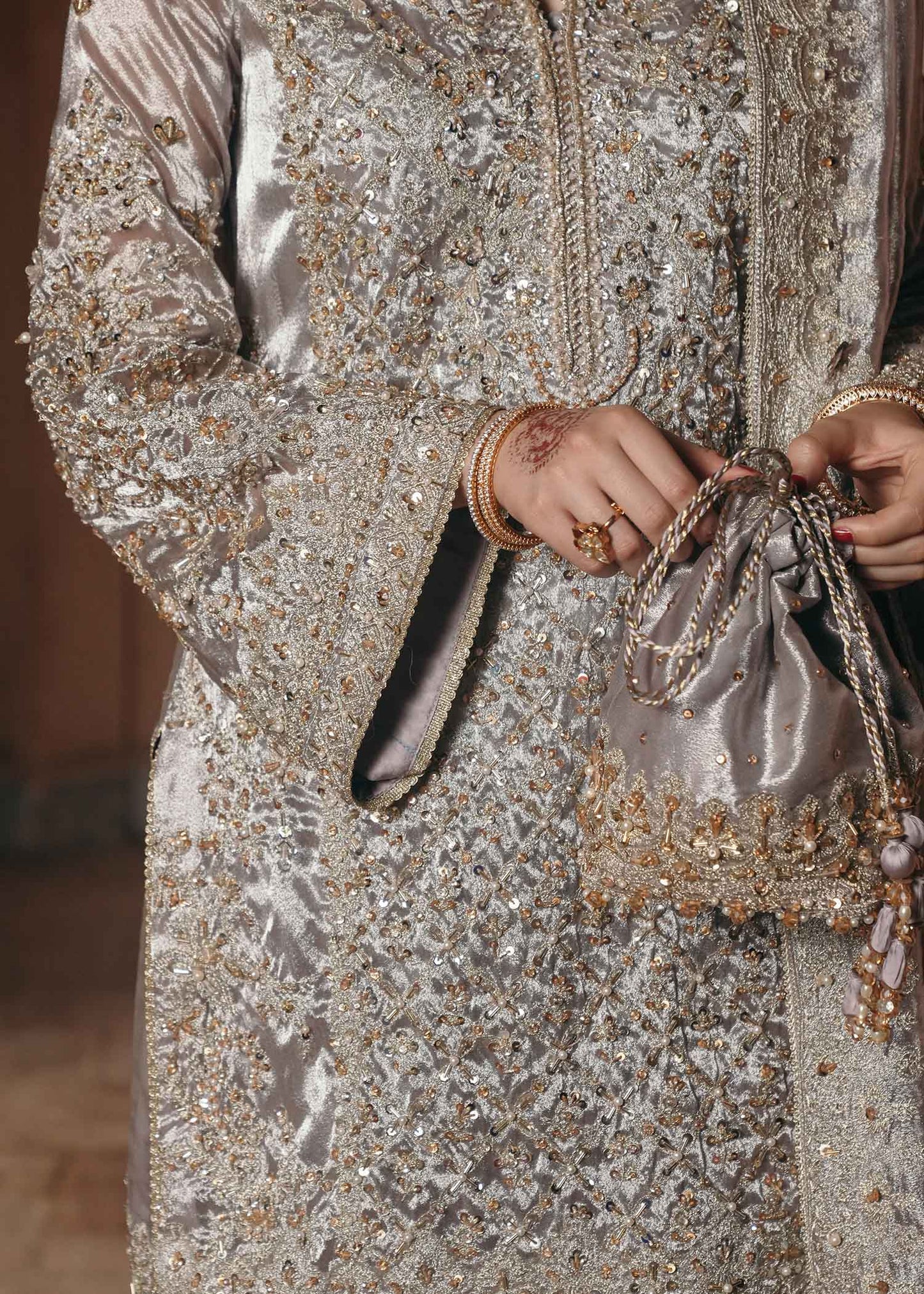Model wearing Gulnaar by Kanwal Malik in metallic silver with intricate embellishments – elegant Pakistani luxury pret outfit in UK.