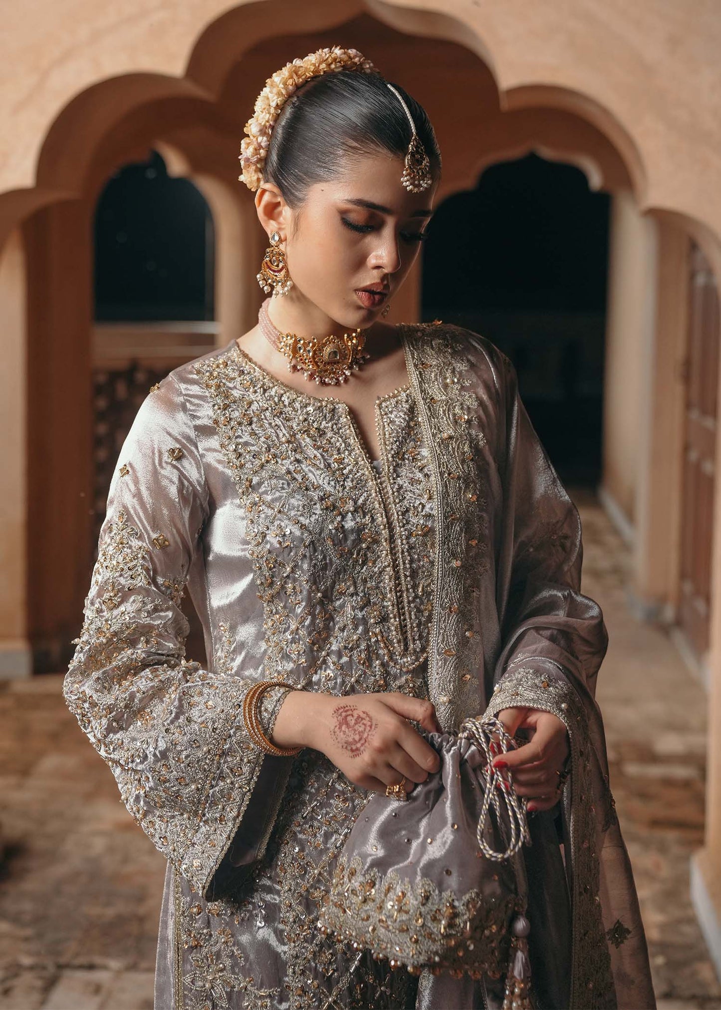 Model wearing Gulnaar by Kanwal Malik in metallic silver with intricate embellishments – elegant Pakistani luxury pret outfit in UK.