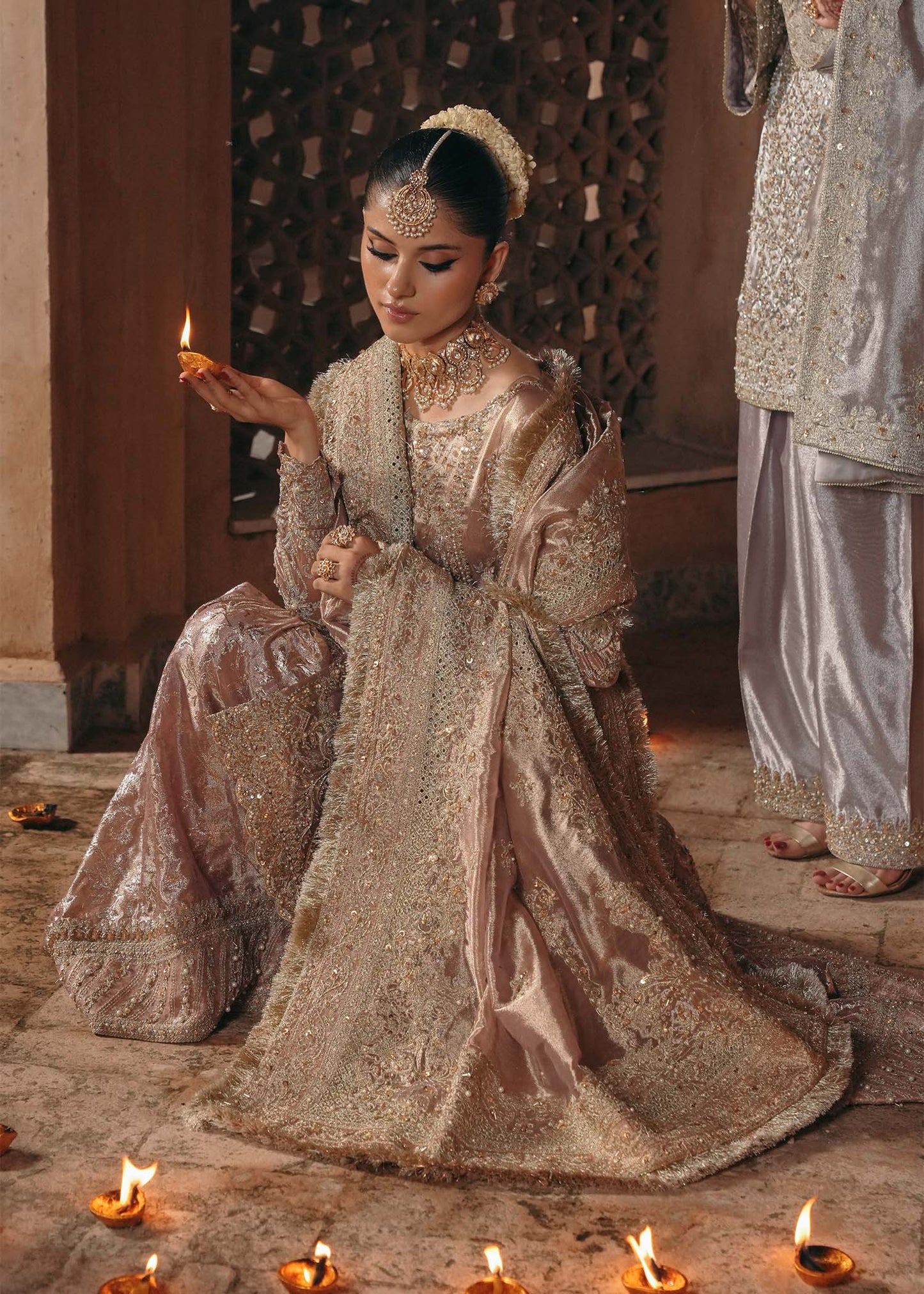 Model wearing Nazo by Kanwal Malik in dusty rose with gold embellishments – elegant Pakistani luxury pret for weddings in the UK.