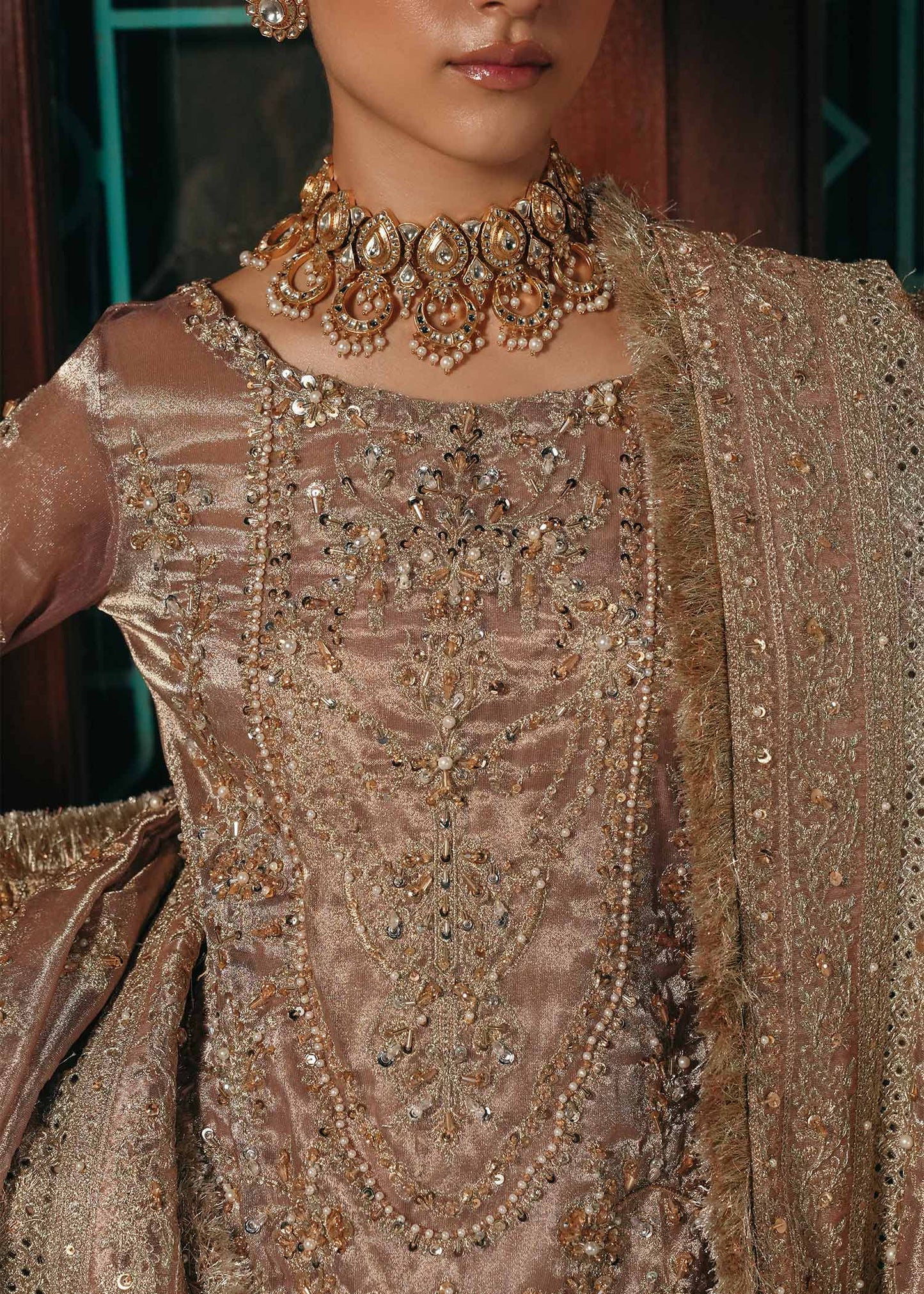 Model wearing Nazo by Kanwal Malik in dusty rose with gold embellishments – elegant Pakistani luxury pret for weddings in the UK.