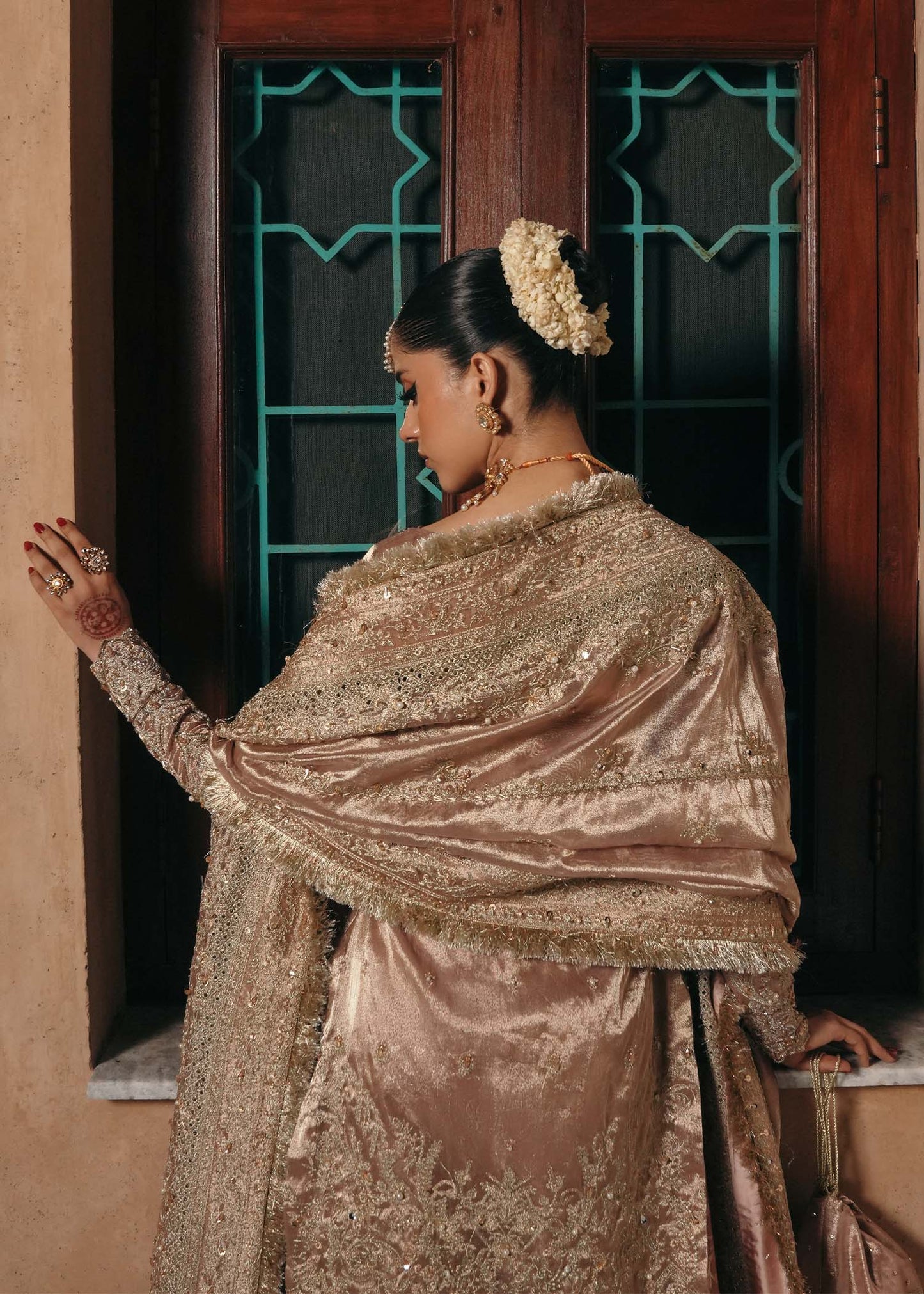 Model wearing Nazo by Kanwal Malik in dusty rose with gold embellishments – elegant Pakistani luxury pret for weddings in the UK.