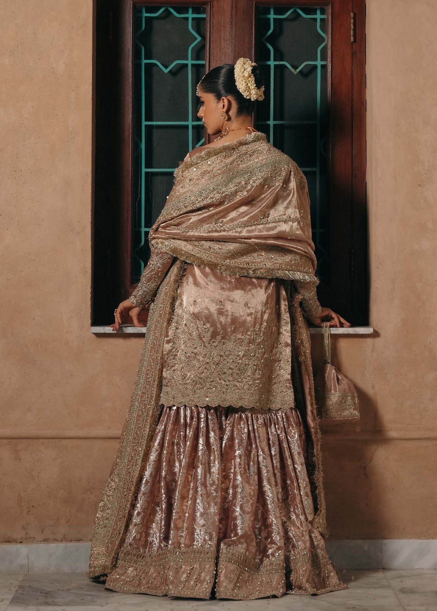 Model wearing Nazo by Kanwal Malik in dusty rose with gold embellishments – elegant Pakistani luxury pret for weddings in the UK.