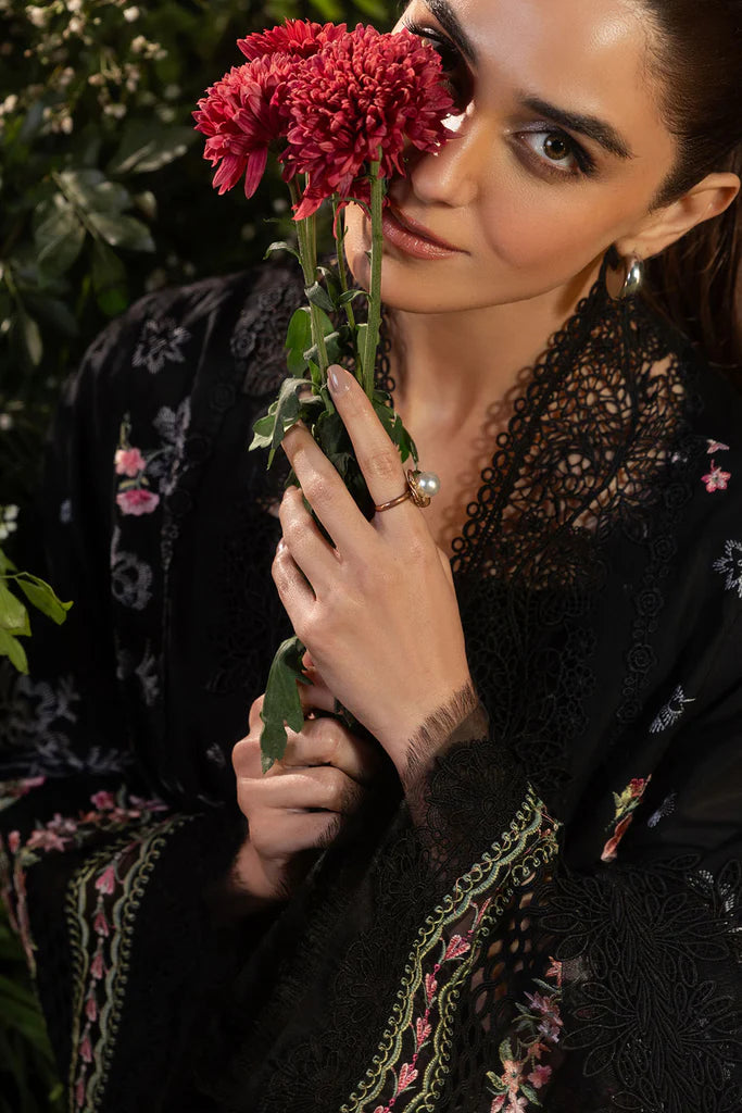 Model wearing Sobia Nazir Design 14B black luxury lawn dress with floral embroidery. Shop Pakistani clothes online in the UK for casual and festive wear.