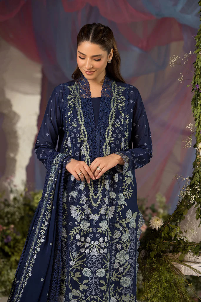 Model wearing Sobia Nazir Design 8A navy blue luxury lawn dress with intricate embroidery. Shop Pakistani clothes online in the UK for casual and festive wear.