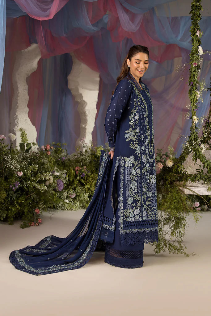 Model wearing Sobia Nazir Design 8A navy blue luxury lawn dress with intricate embroidery. Shop Pakistani clothes online in the UK for casual and festive wear.