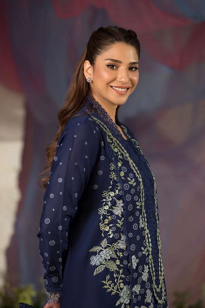 Model wearing Sobia Nazir Design 8A navy blue luxury lawn dress with intricate embroidery. Shop Pakistani clothes online in the UK for casual and festive wear.