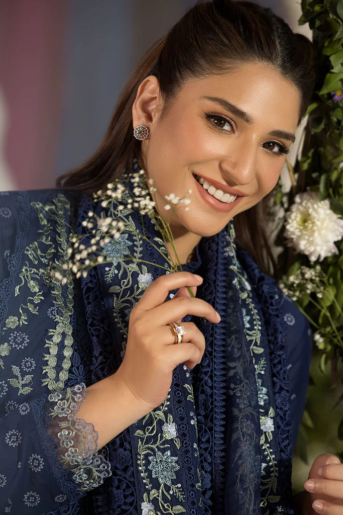 Model wearing Sobia Nazir Design 8A navy blue luxury lawn dress with intricate embroidery. Shop Pakistani clothes online in the UK for casual and festive wear.