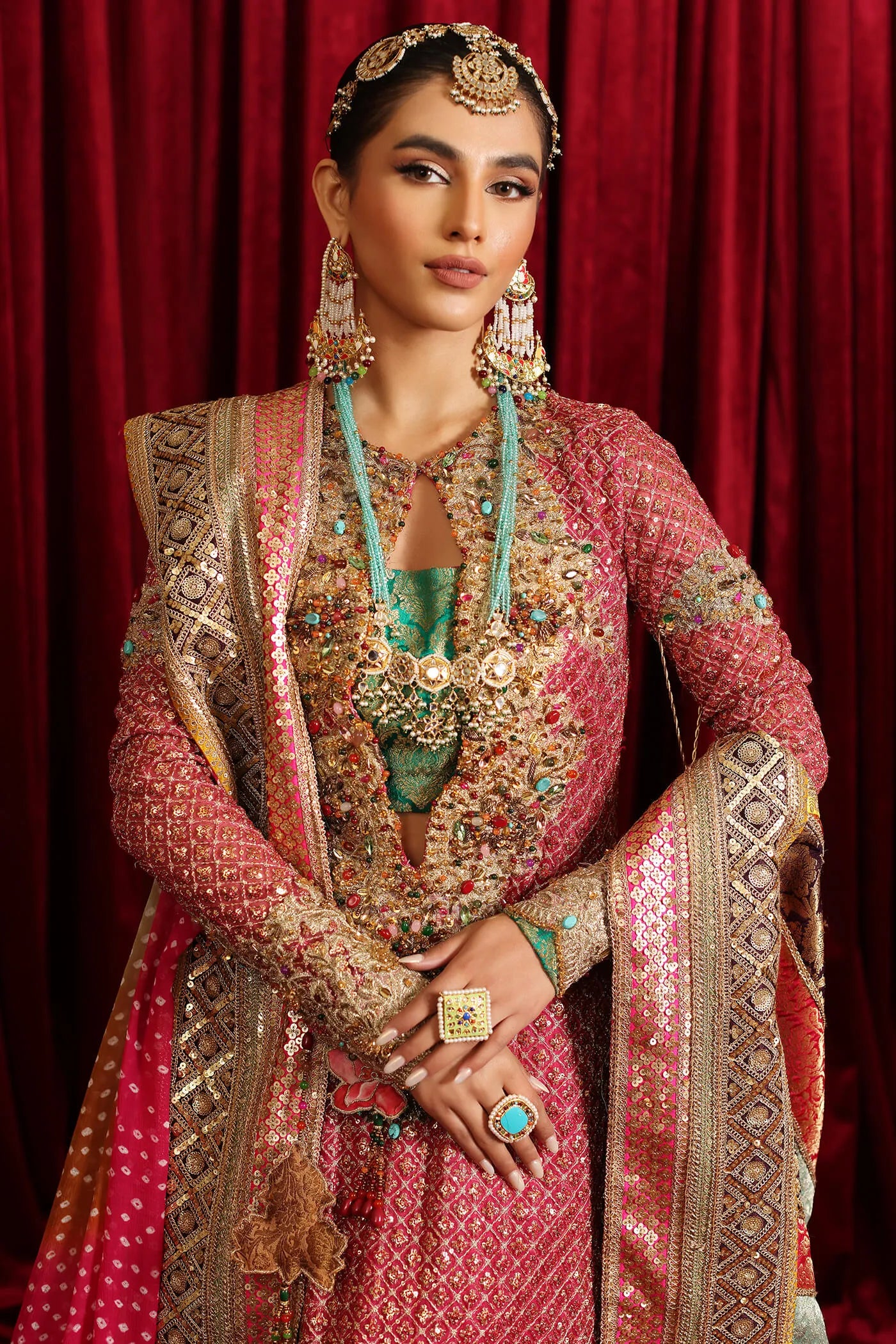 Model in Musferah Saad Serene Light, traditional shocking pink Pakistani bridal dress, UK.