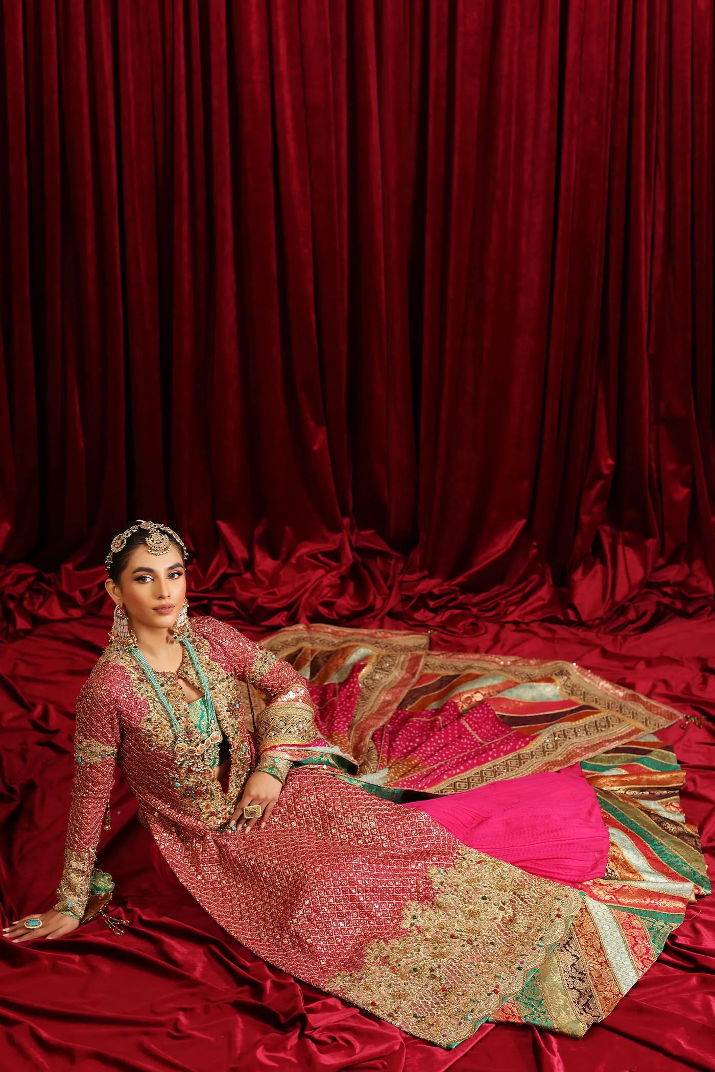Model in Musferah Saad Serene Light, traditional shocking pink Pakistani bridal dress, UK.
