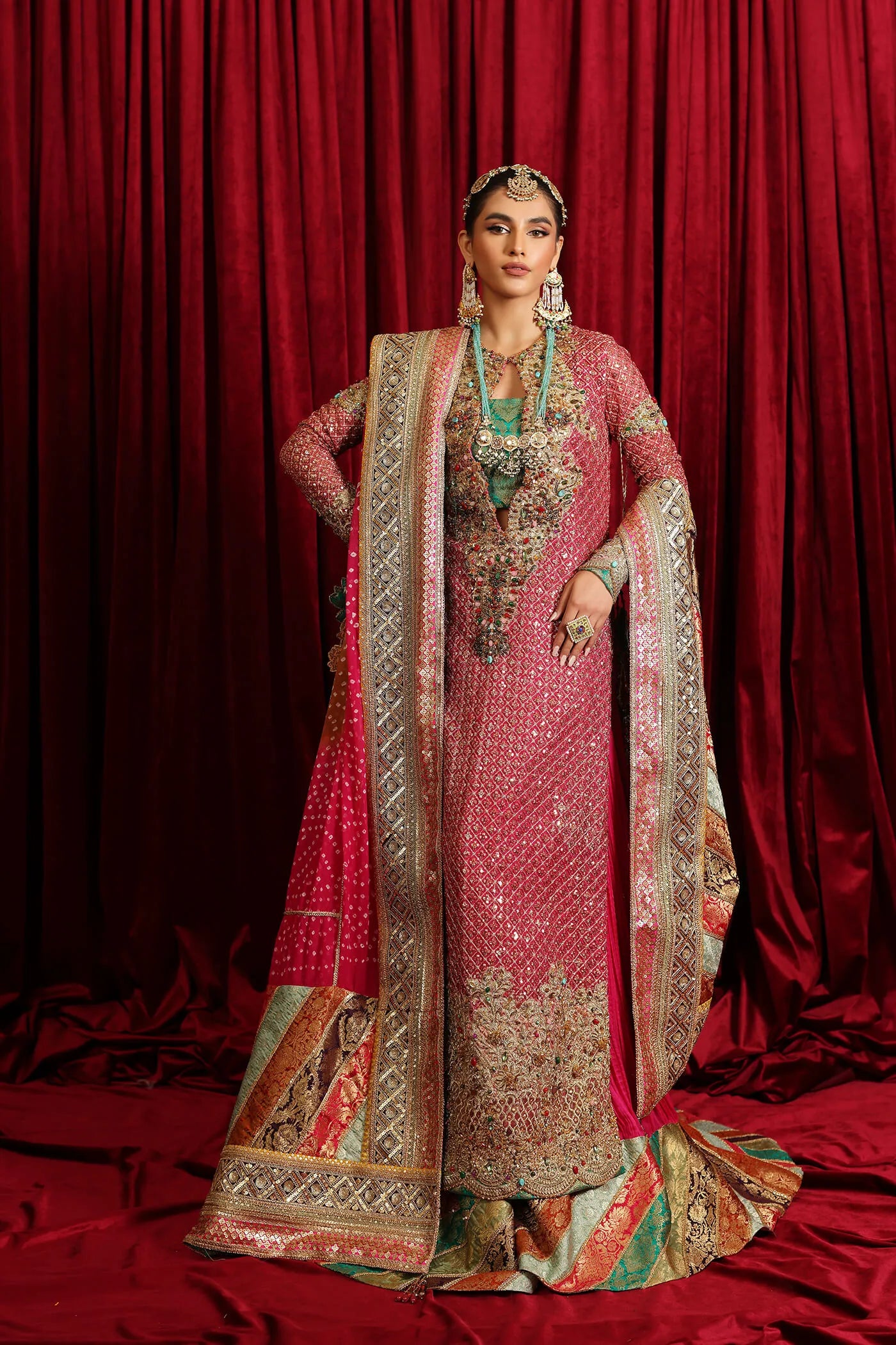 Model in Musferah Saad Serene Light, traditional shocking pink Pakistani bridal dress, UK.