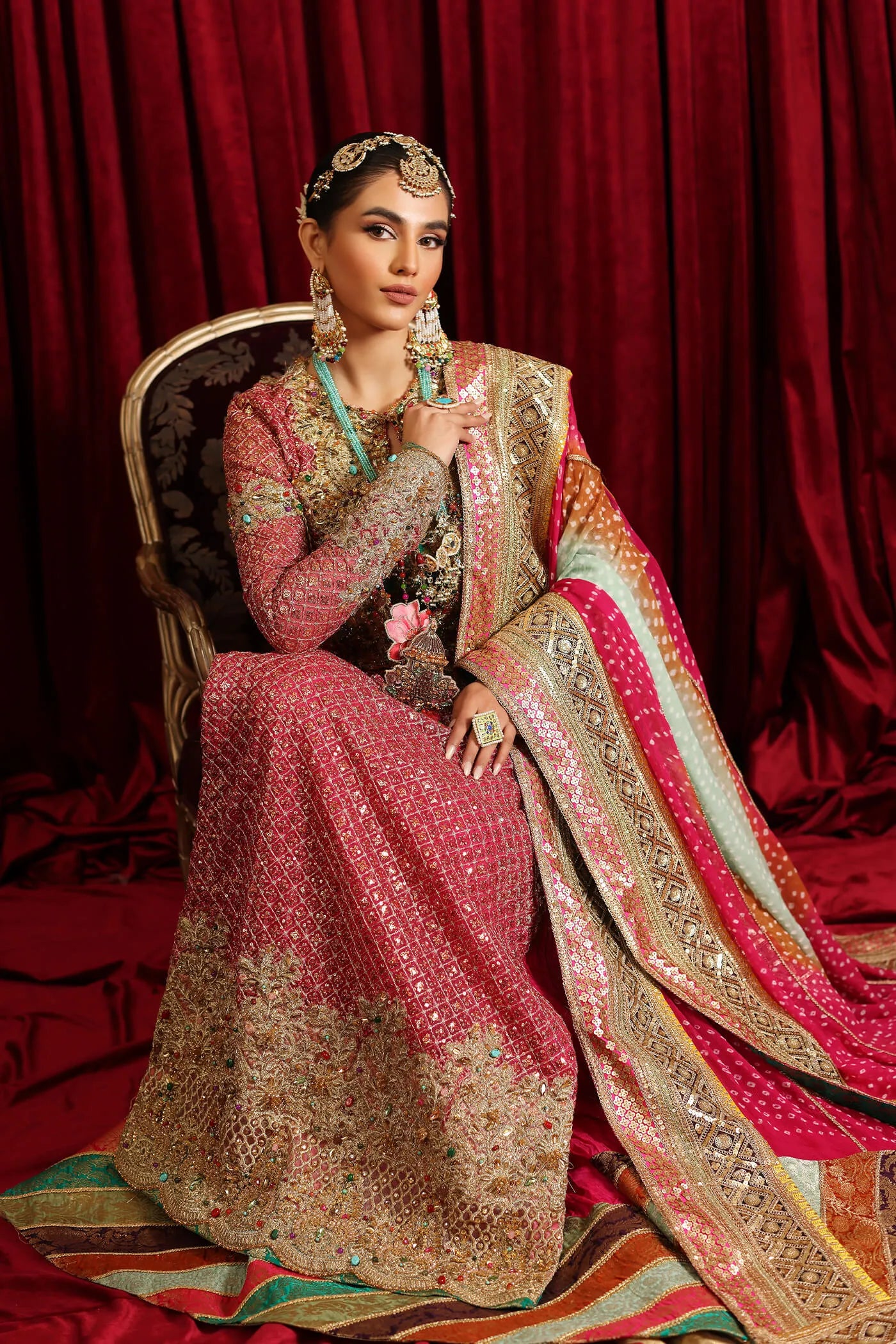 Model in Musferah Saad Serene Light, traditional shocking pink Pakistani bridal dress, UK.