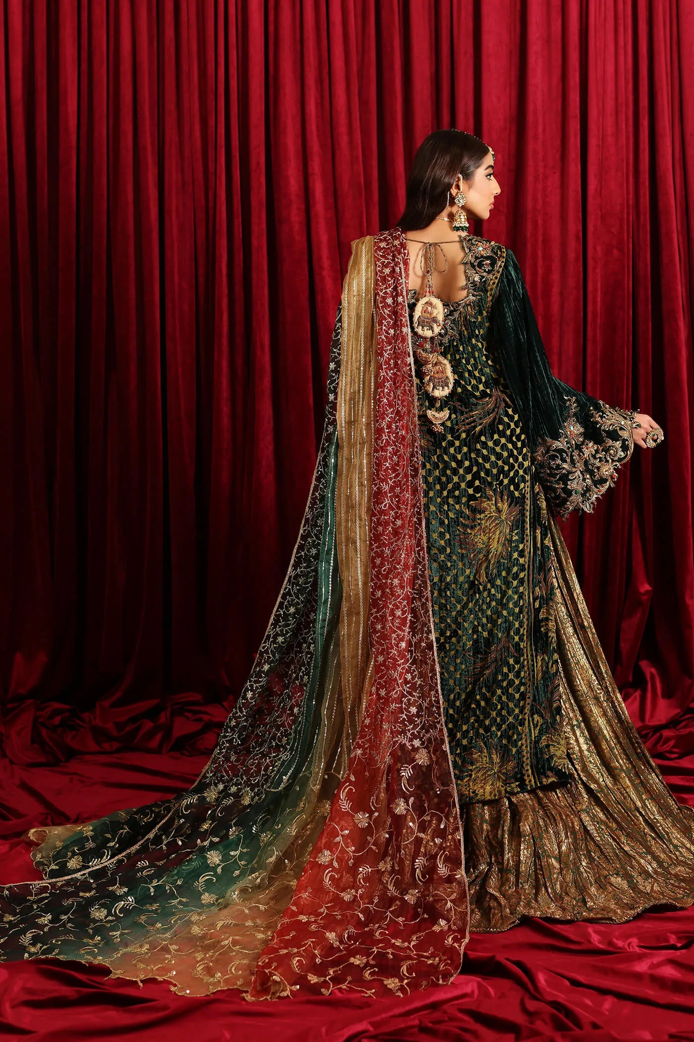 Model in Musferah Saad Radiant Spell, an emerald green Pakistani bridal dress in the UK.