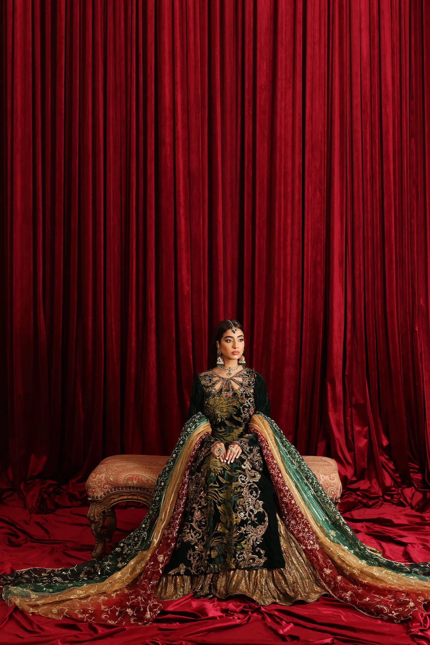 Model in Musferah Saad Radiant Spell, an emerald green Pakistani bridal dress in the UK.