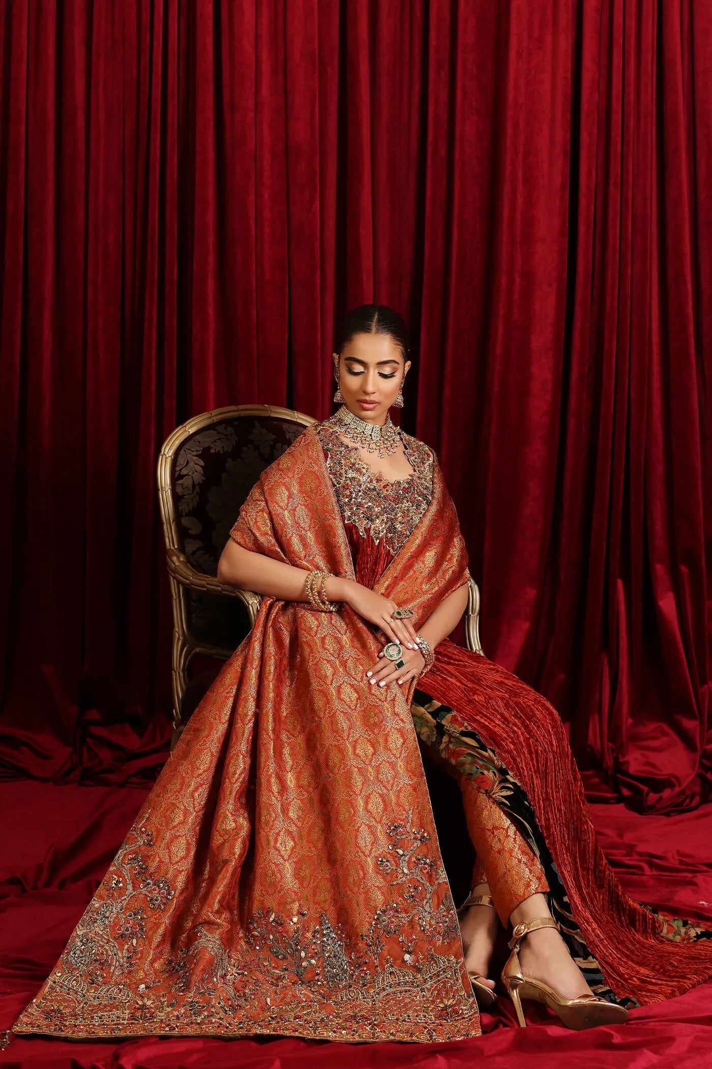 Model in Musferah Saad Sunstone Symphony, a rust Pakistani bridal dress in the UK.