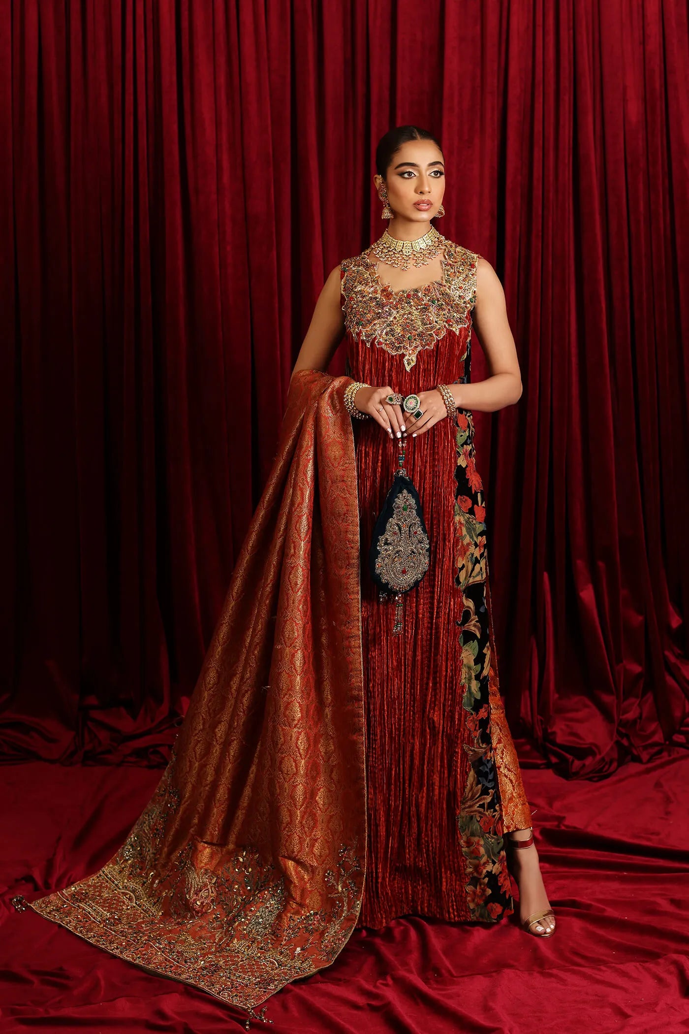 Model in Musferah Saad Sunstone Symphony, a rust Pakistani bridal dress in the UK.