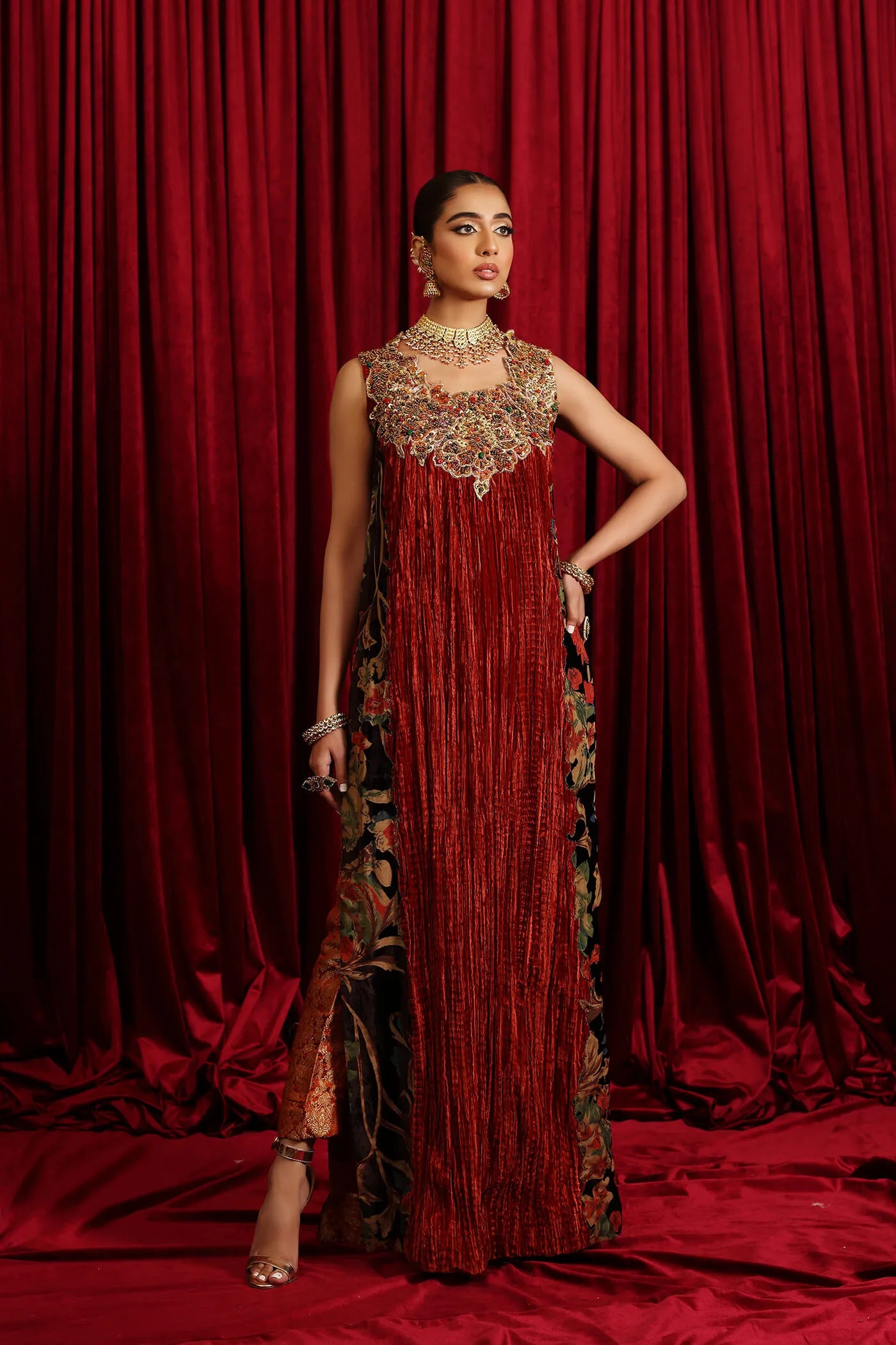 Model in Musferah Saad Sunstone Symphony, a rust Pakistani bridal dress in the UK.