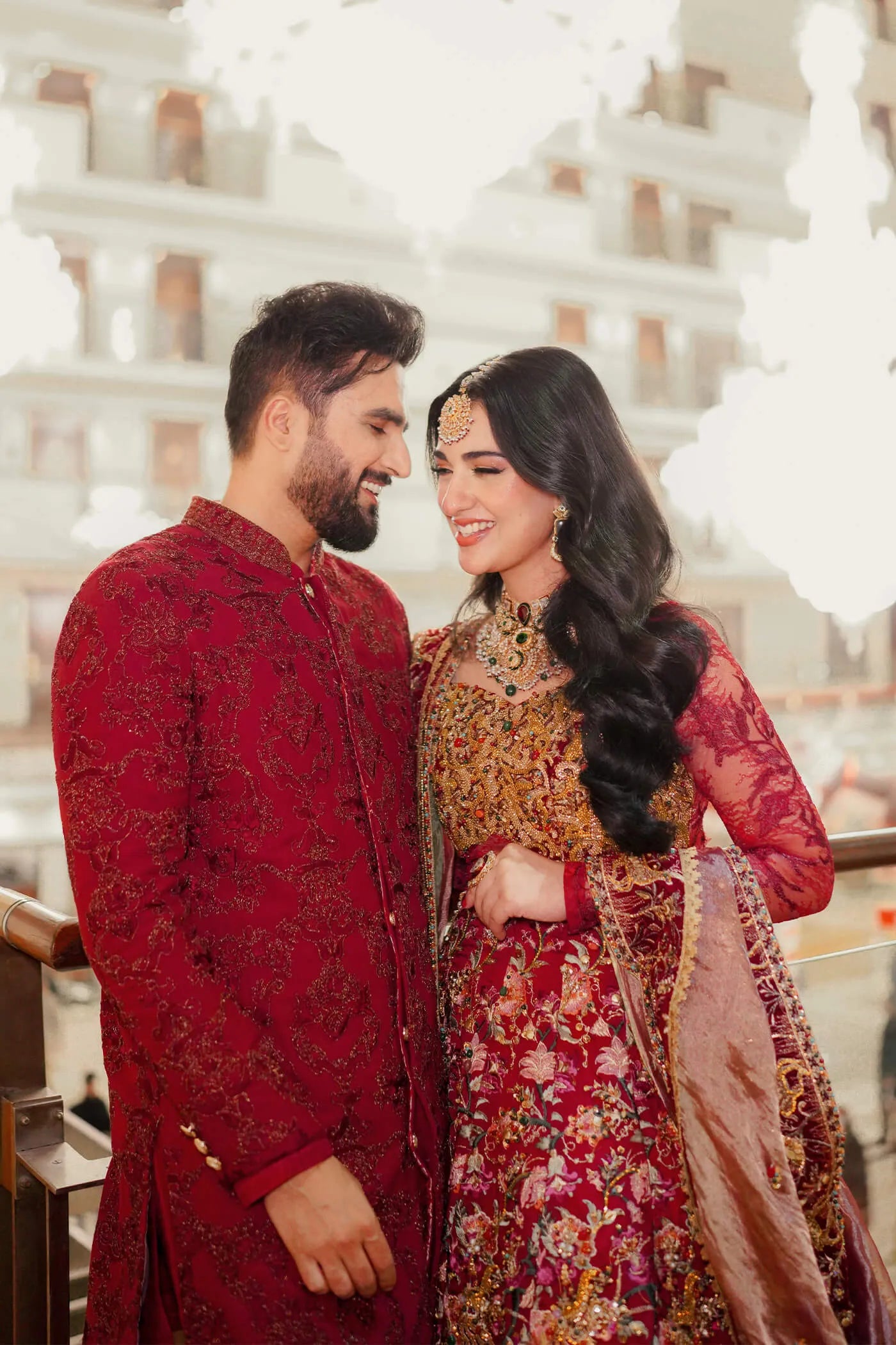Couple in Musferah Saad Scarlet Monarch, Pakistani bridal dress and sherwani in UK.