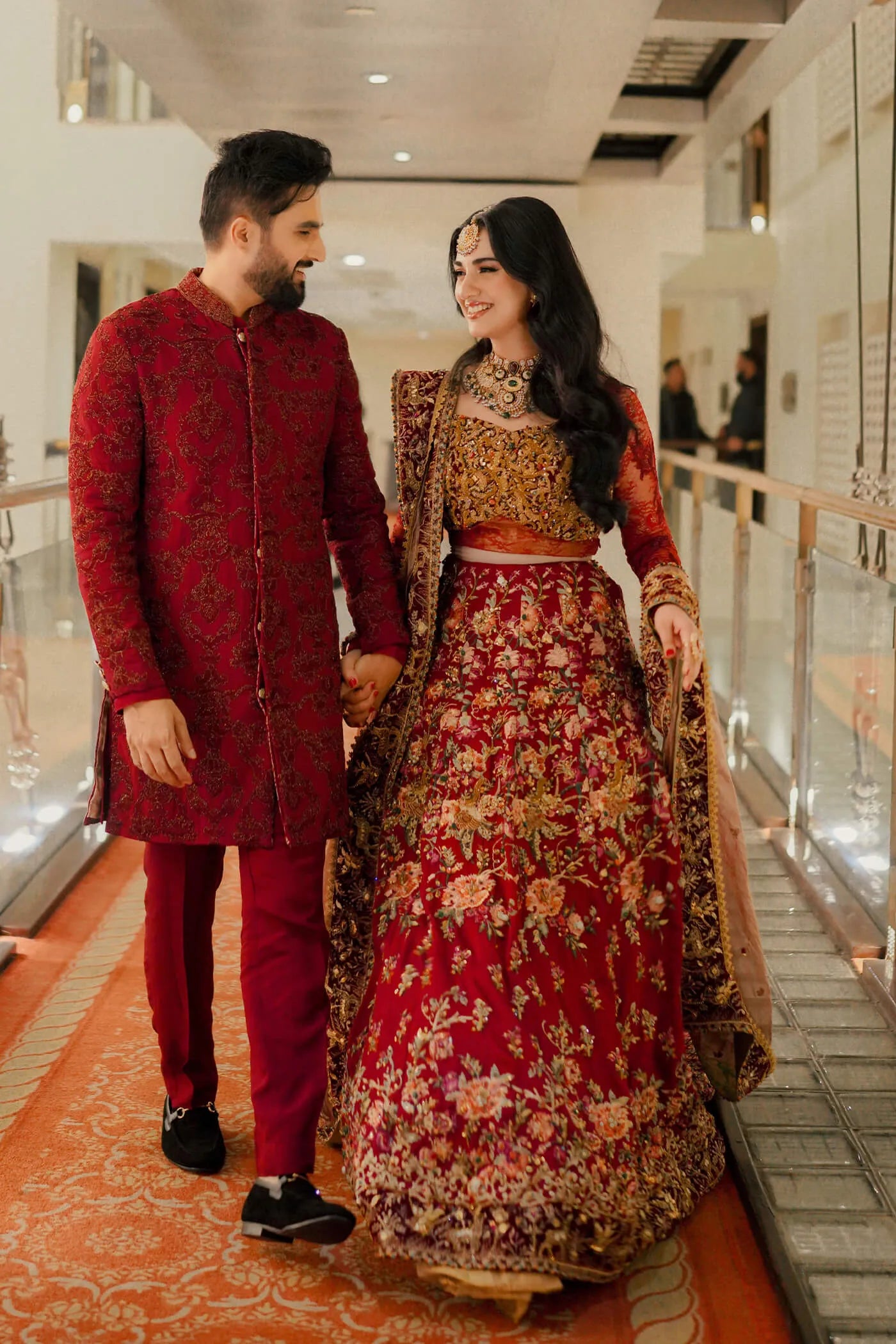 Couple in Musferah Saad Scarlet Monarch, Pakistani bridal dress and sherwani in UK.
